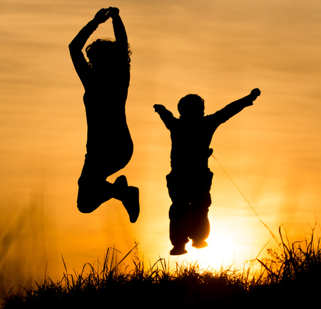 Silhouette of Mom and son in the rays of sunset .の写真素材