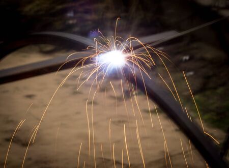 Sparks from welding at the construction site .