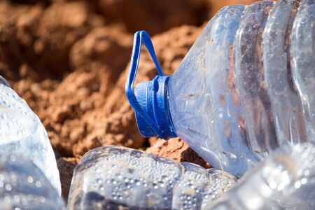 Blue plastic water bottle in the nature .