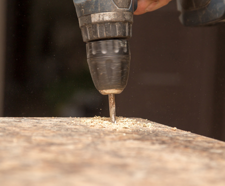 The master cuts the wood with a drill .の写真素材