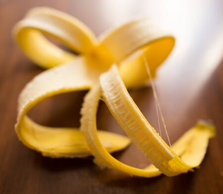 Skin from a banana lies on a table .