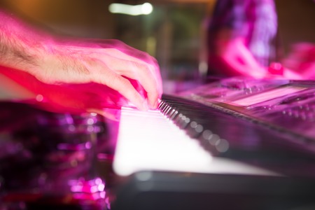 Musician plays keyboards in a rock band .の写真素材