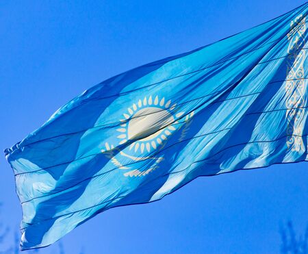 Flag of Kazakhstan against the blue sky .の写真素材