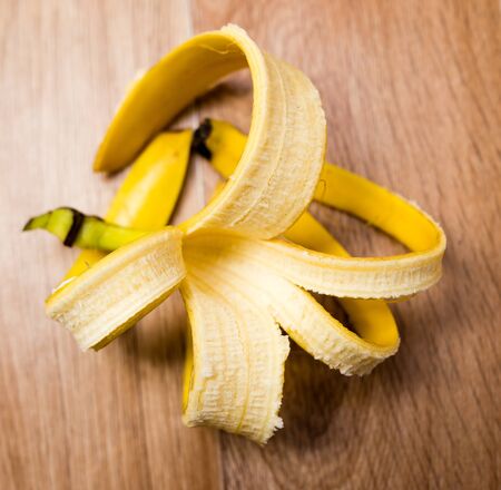 Skin from a banana lies on a table .の写真素材