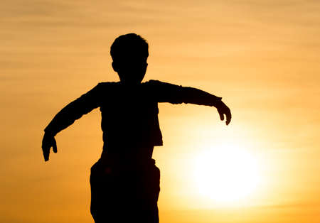 Silhouette of a Boy in the Sunset .の写真素材