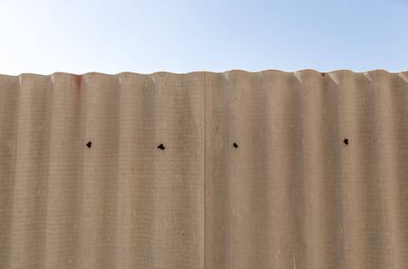 Slate fence and blue sky as background .の写真素材