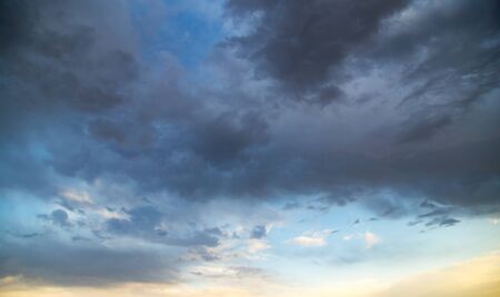 Storm clouds in the sky at sunset as background .