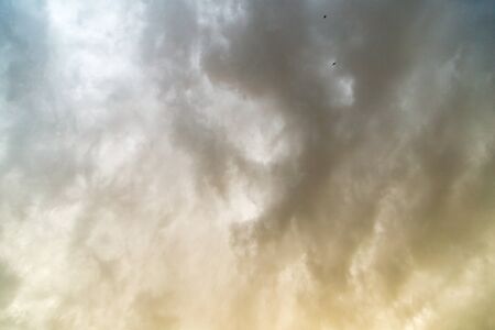 Storm clouds in the sky at sunset as background .