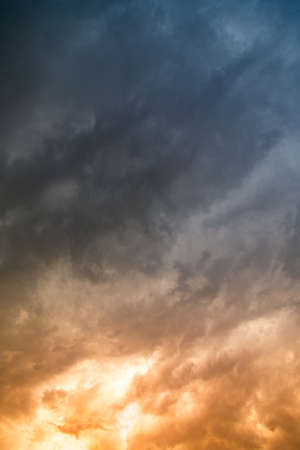Storm clouds in the sky at sunset as background .