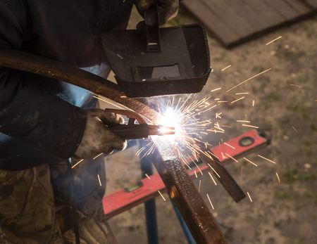 Sparks from welding at the construction site .