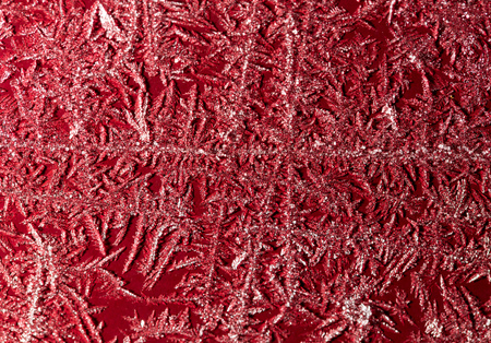 Snowflake on a red fence as a background. Macro