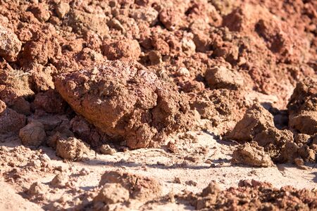 Red clay soil on nature as a background .