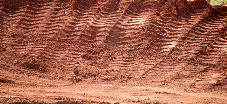 Traces from the car on the red clay soil .の写真素材
