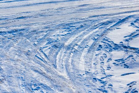 Traces of auto on snow as background .の写真素材