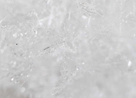 Small snowflakes on nature as background. Macro