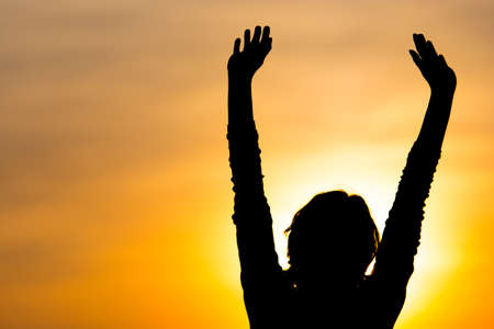 Silhouette of a girl in the sunset .の写真素材