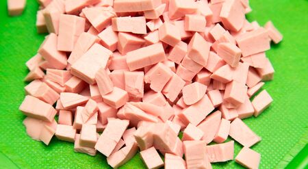 Slicing sausage with a knife on the board .の写真素材