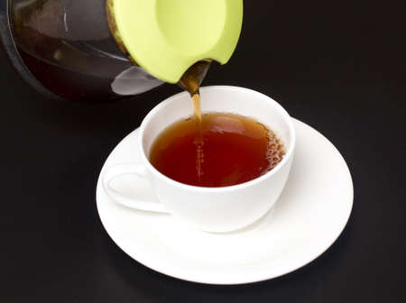 Tea in a cup on a black backgroundの写真素材