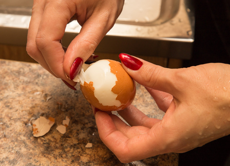 The girl clears the egg from the shell