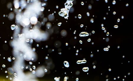 Splashing water from a fountain as an abstract backgroundの写真素材