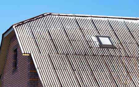 Snow on the roof of the house in winter .の写真素材