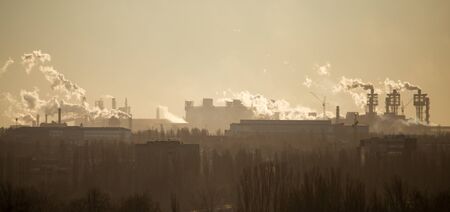 Smoke from the pipes of an industrial plant in the morning .の写真素材