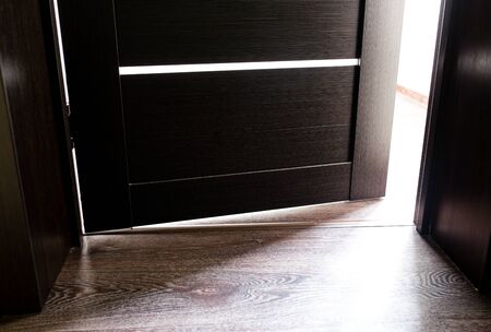 Rays of light from the door in a dark room .の写真素材