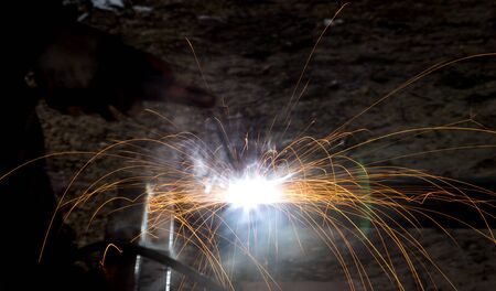 Flash and sparks from electric welding as a background