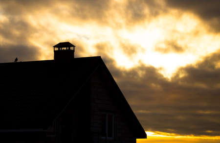 House in the village at sunset as a background .の写真素材