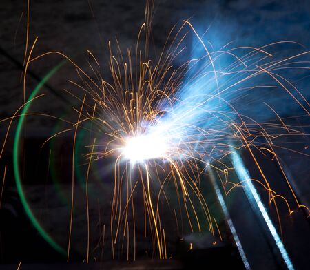 Flash and sparks from electric welding as a background
