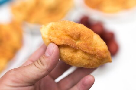 A man holds a patty in his hand .の写真素材