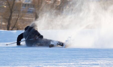 the man on skis fell into the snow .の写真素材