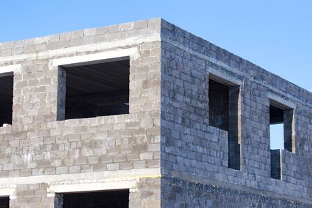 Windows in a brick house under construction as a background