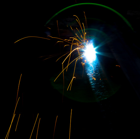 Flash and sparks from electric welding as a background