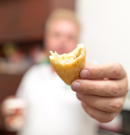 A man holds a patty in his hand .の写真素材