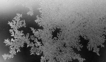 Black and white drawings on the glass in the frost .
