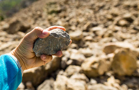 Stone in hand in the mountainsの写真素材