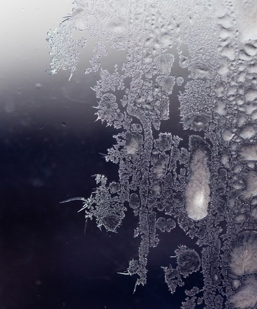Black and white drawings on the glass in the frostの写真素材