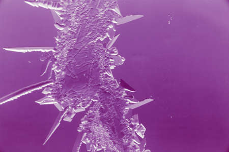 Purple patterns on the glass in the frost