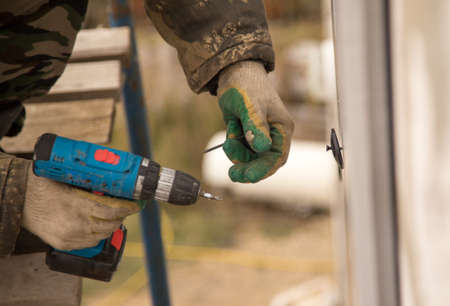 The man insulates the house with foam blocks .