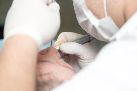 A dentist makes teeth to a woman .の写真素材