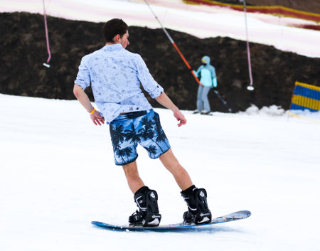 LIPETSK, RUSSIA - MARCH 31, 2018: A man snowboarding from mountain to waterのeditorial素材