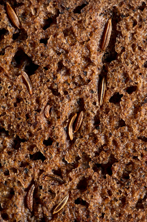 sesame seeds on black bread as a backgroundの写真素材