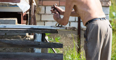 The old man works with a board in the countryの写真素材