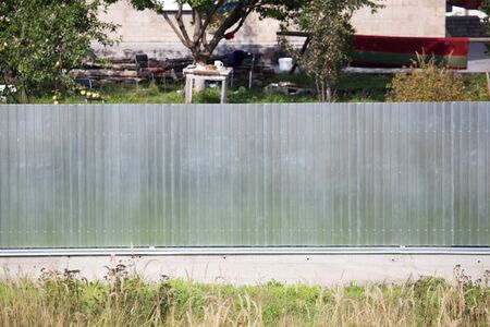 Metal fence on the cottage siteの写真素材