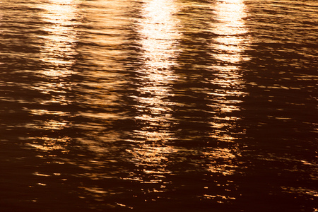 Light of lanterns on the smooth surface of water at night as a background .
