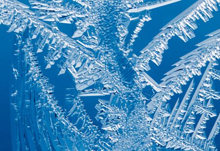 Blue drawings on the glass in the frost