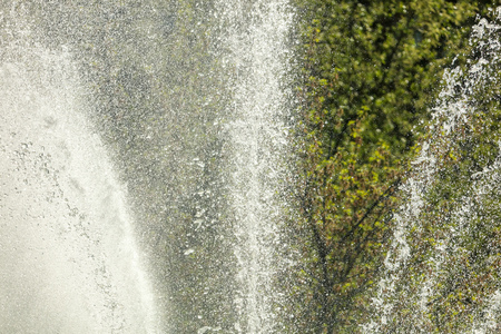 Spray from the fountain in the city as a background .の写真素材
