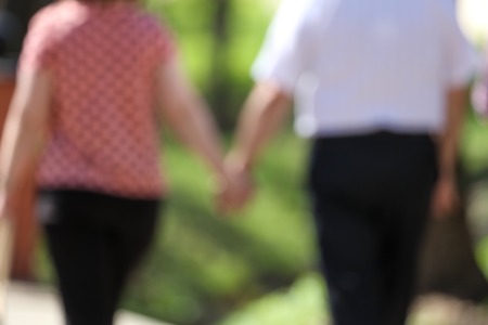 Grandpa and grandmother are walking in the park. Bokeの写真素材