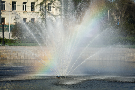 Rainbow in splashes of a fountain as an abstract background .の写真素材